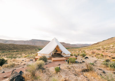 Luxury camping tent in desert landscape at dusk